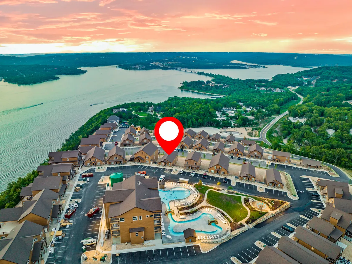 An inviting exterior scene featuring a swimming pool set beside a serene waterfront, with a view of the neighborhood layout that includes walking areas and natural greenery. The setting conveys a relaxed, outdoor lifestyle with easy access to both water and communal spaces.